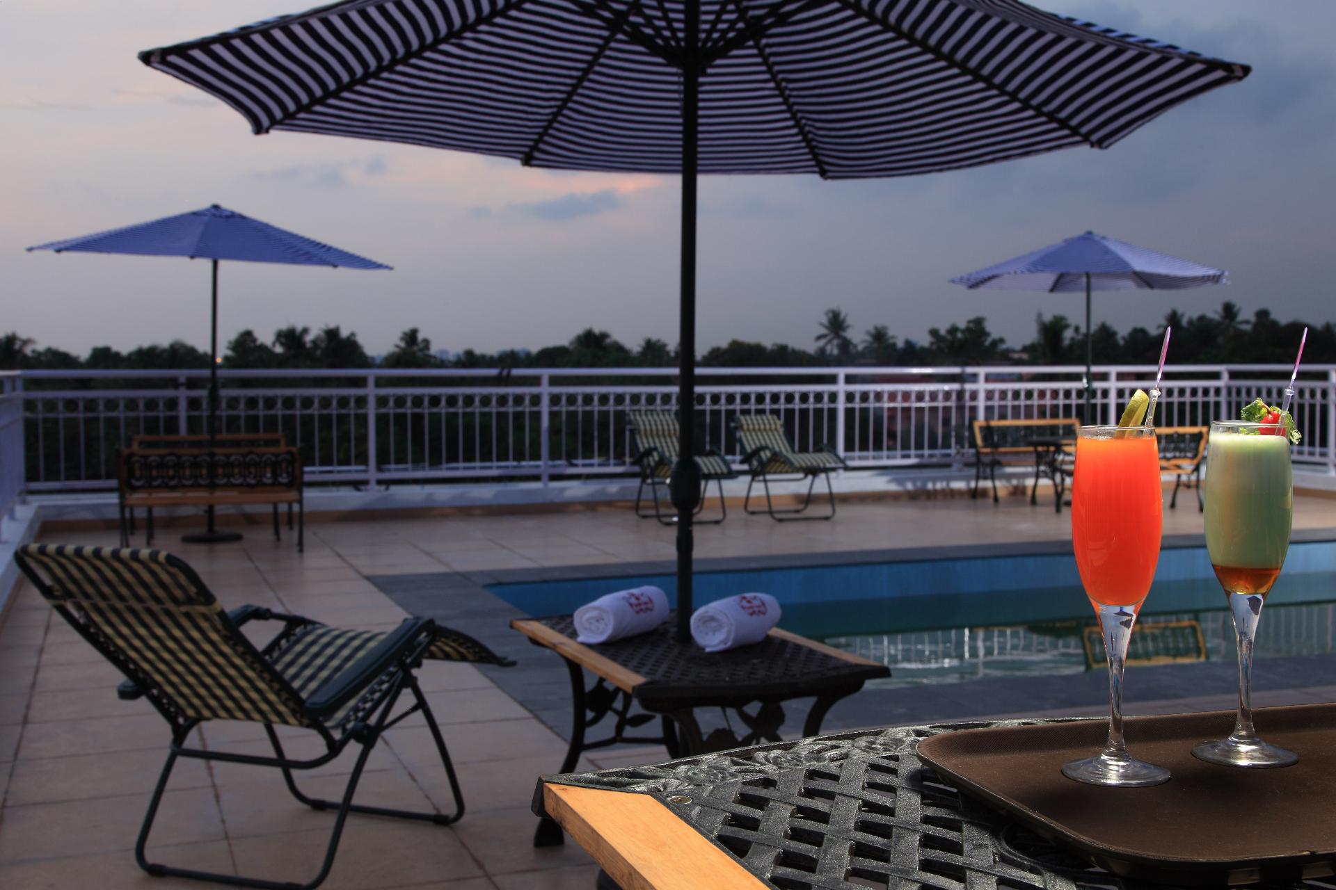 Poolside loungers and refreshments at dusk